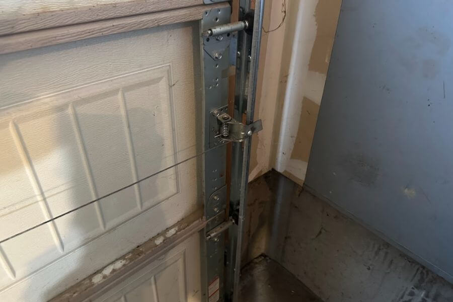 technician repairing garage door frame