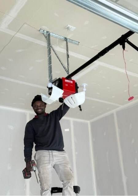 technician performing new garage door opener installation in ottawa